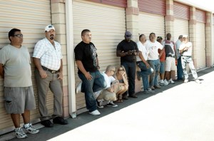 People waiting to bid on someone's forgotten stuff.