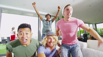 stock-footage-happy-group-of-male-friends-watching-sports-on-tv-and-cheering-on-their-team-in-slow-motion